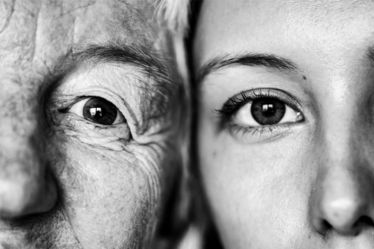 Black and white image of two faces pressed together: one a grown-up wise woman, one a young woman