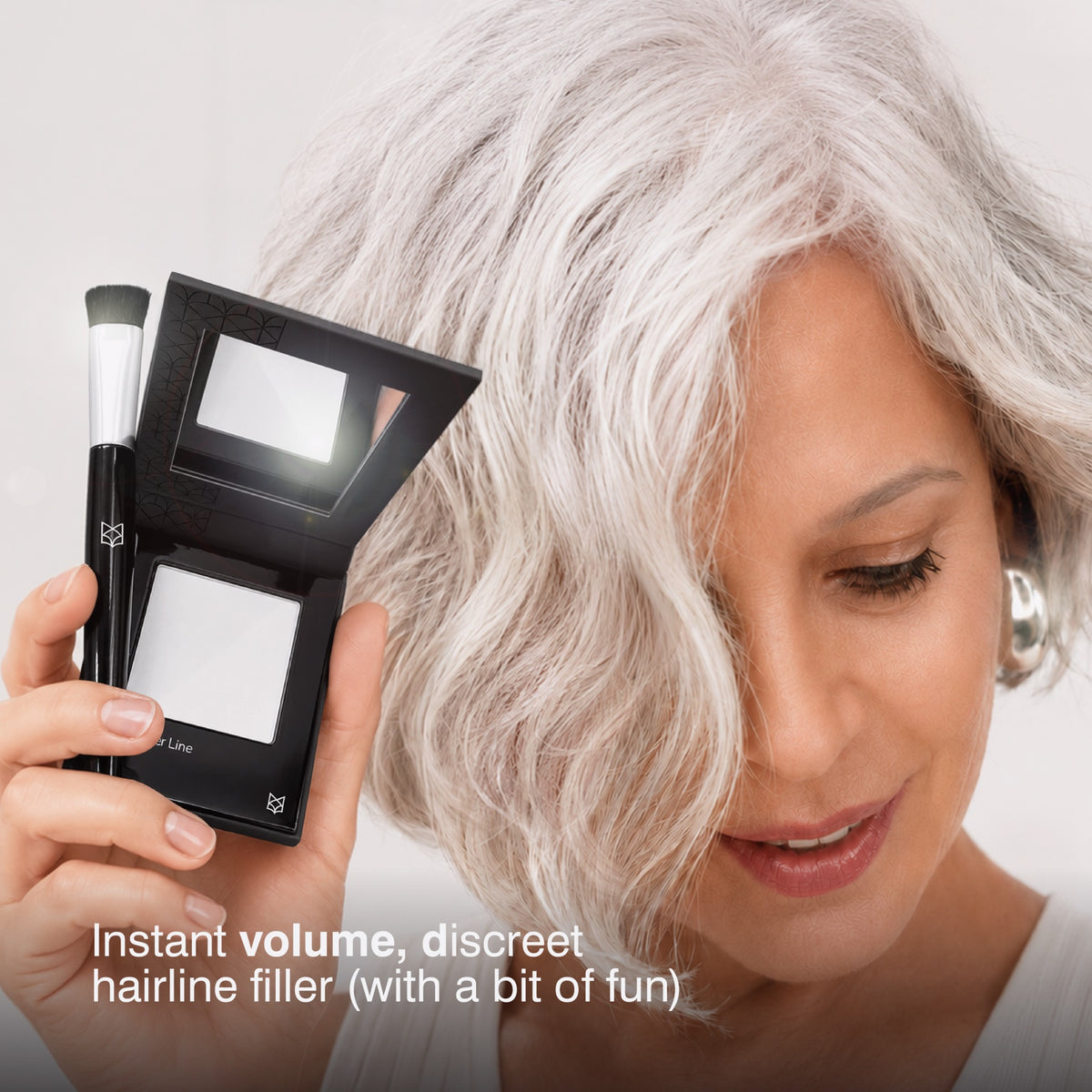 Woman with silver hair holding Border Line White optical hair filler compact and brush